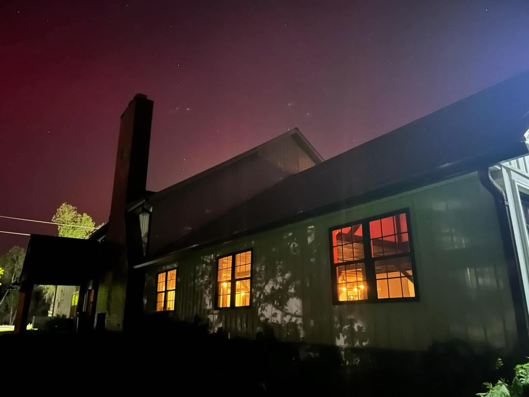 The Oaks at Kiser Lake lodge at night under a crimson sky
