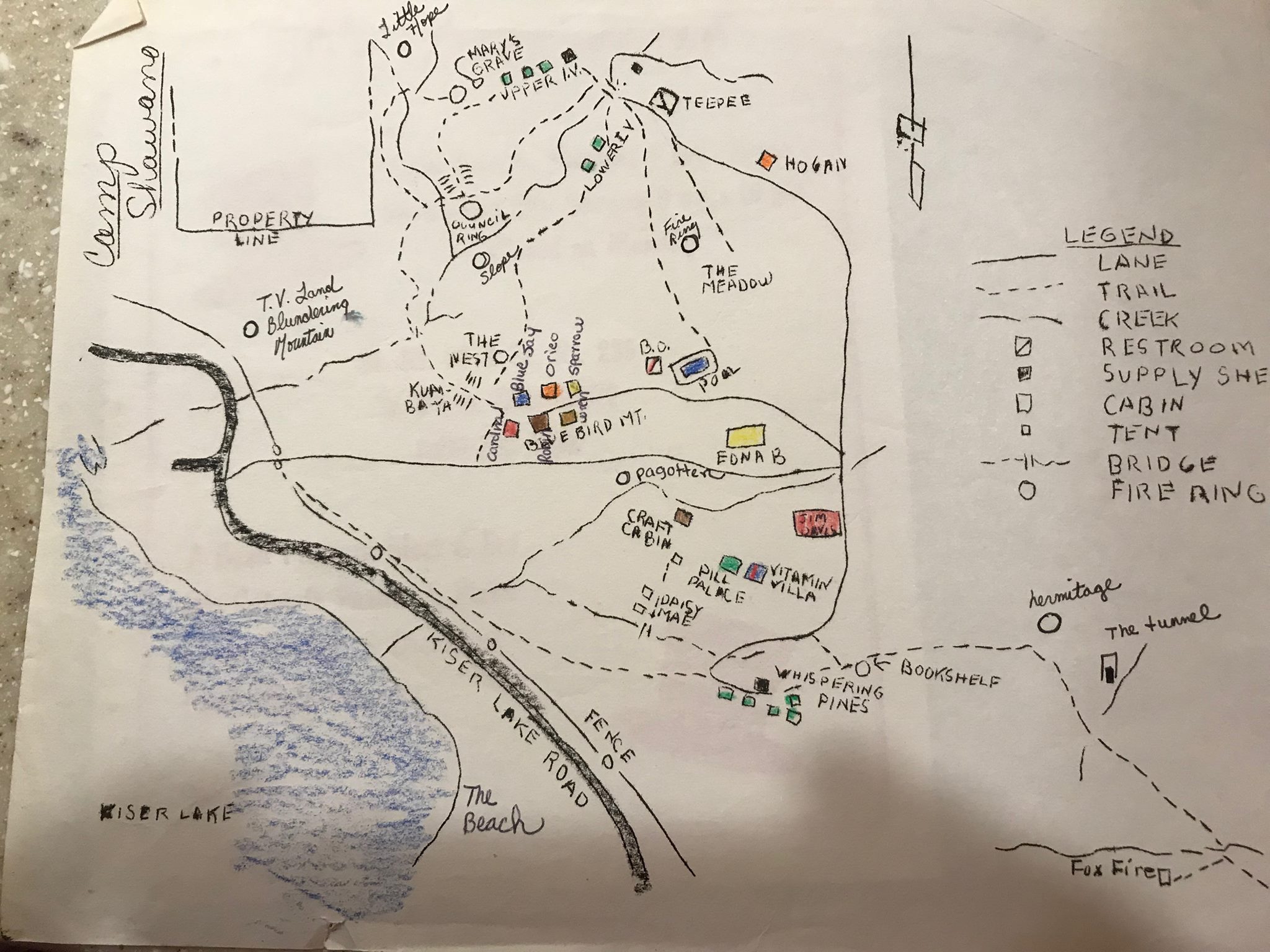 Hand-drawn map of Camp Shawano showing landmarks, cabins, and trails along Kiser Lake